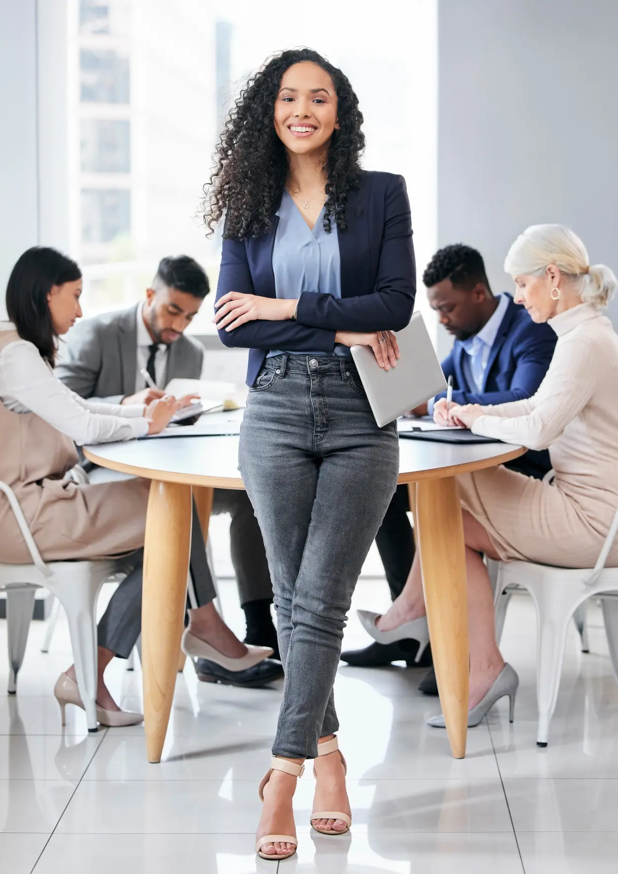 confident business woman standing in front of a group of business people