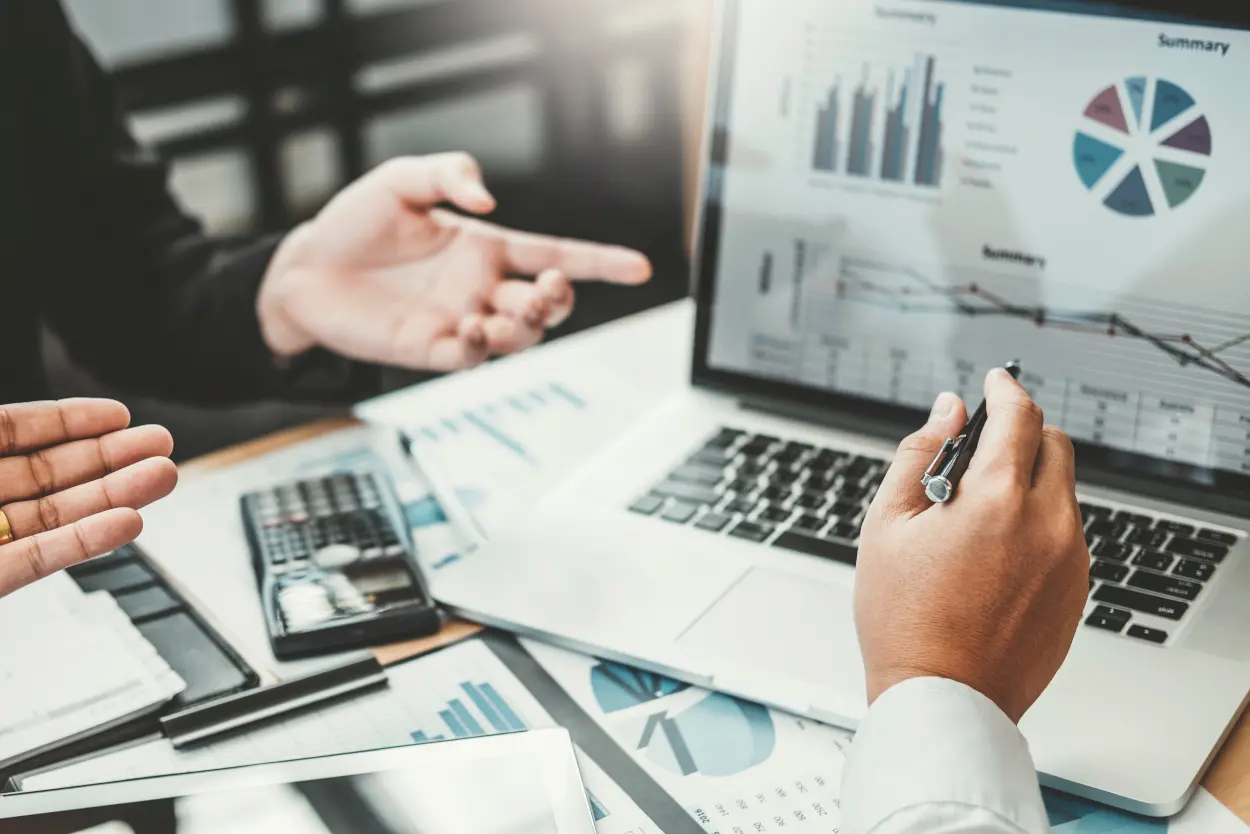 business consultant and his client reviewing graphs on a laptop