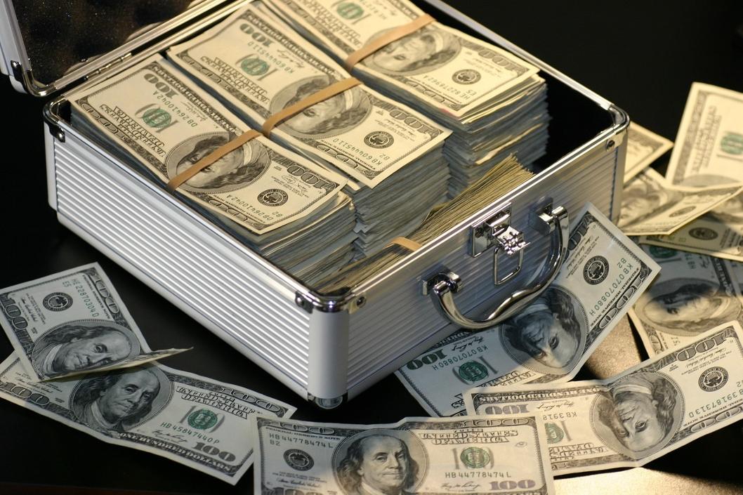 pile of money in a metal briefcase